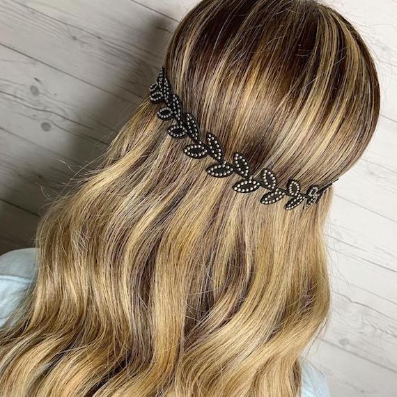 Foto des Hinterkopfes einer Frau mit gewelltem, dirty blondem Haar, kreiert mit Wella Professionals