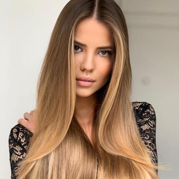 Woman with blonde face-framing highlights, created using Wella Professionals.