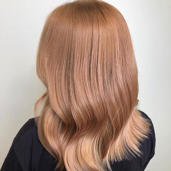 Photo of the back of a woman’s head with strawberry blonde hair, created using Wella Professionals