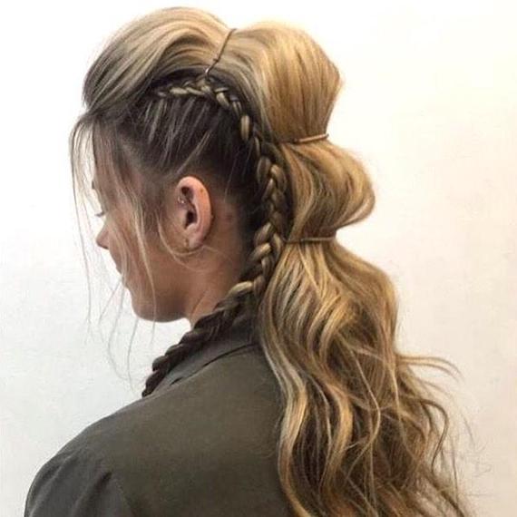 Back shot of model with long, wavy hair, styled with a faux undercut and mohawk.