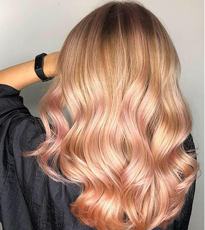 Model with blonde hair and peach balayage created with Blondor and Color Touch