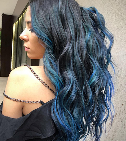 Model with long dark hair with blue and purple highlights created with Blondor and Color Fresh Create