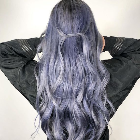 Back of model’s head with long, loosely curled, ash blue and dark grey hair.
