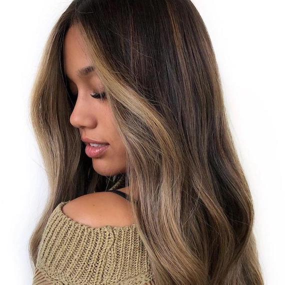 Photo of woman with brunette balayage and money piece highlights, created using Wella Professionals.