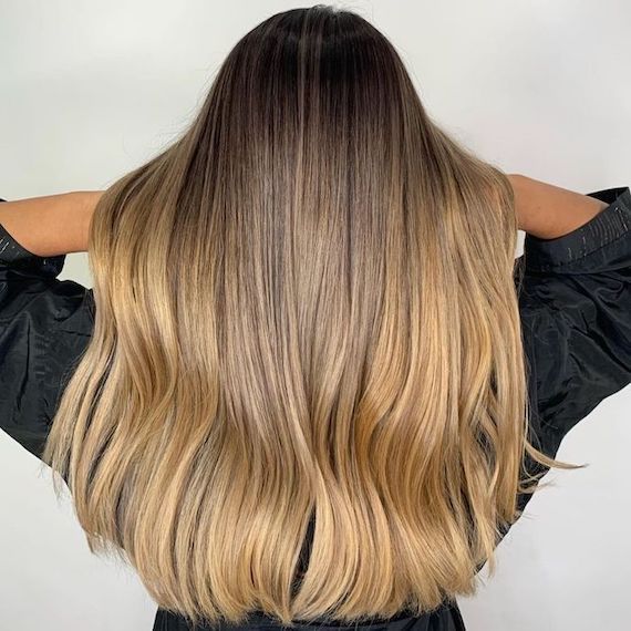 Back of model’s head with long, caramel blonde ombre hair.