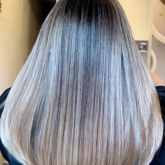Back of model’s head with long, straight, blonde ombre hair.
