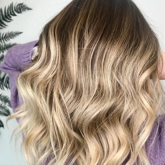 Back of woman’s head with cool-toned, wavy hair, created using Wella Professionals.