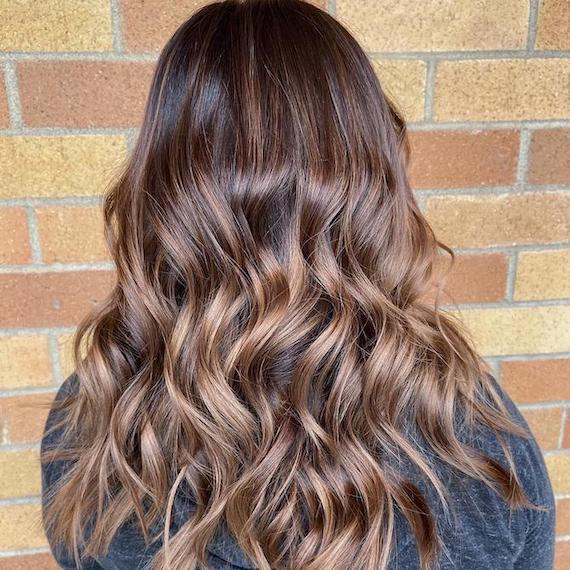 Hinterkopf einer Frau mit Balayage von einem kühlen Braun zu Blond, kreiert mit Wella Professionals.