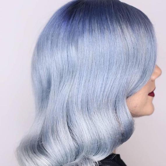 Side profile of woman with icy blue ombre hair, created using Wella Professionals.