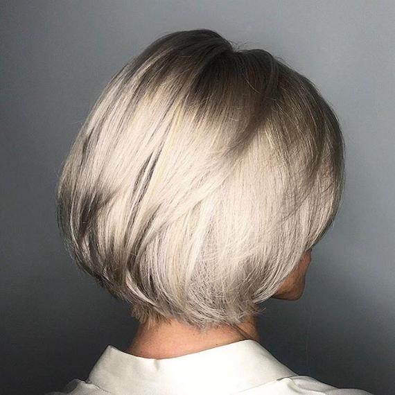 Woman with short, blonde, layered bob, created using Wella Professionals