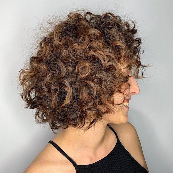 Woman with curly, brunette bob, created using Wella Professionals