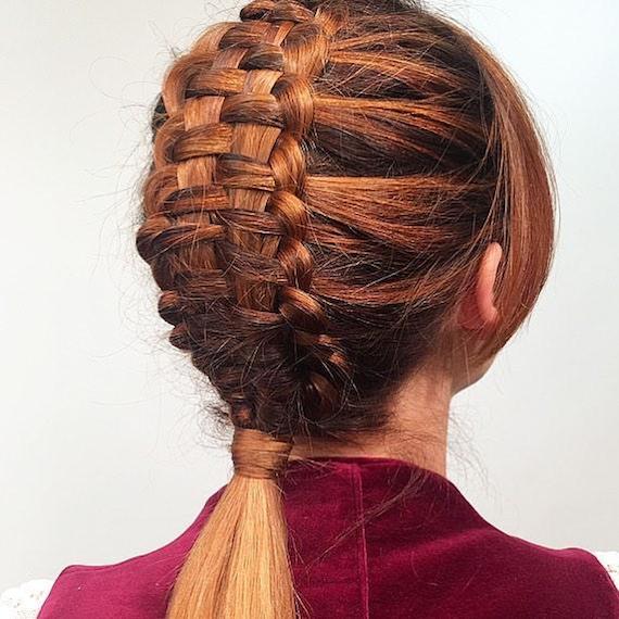 Back of woman’s head with copper tapestry braid, created using Wella Professionals.