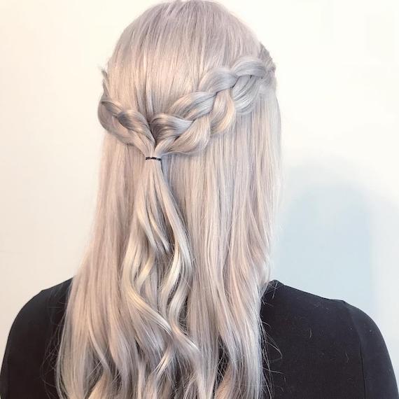 Back of woman’s head with ice blonde, half-up inside out braid, created using Wella Professionals.