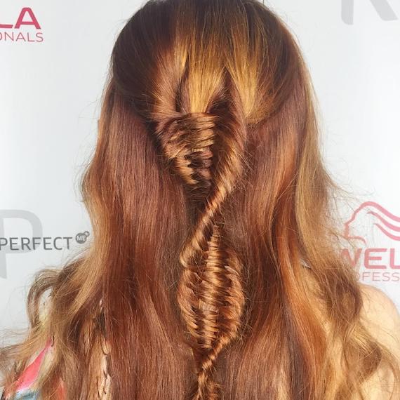 Back of woman’s head with copper DNA braid, created using Wella Professionals.