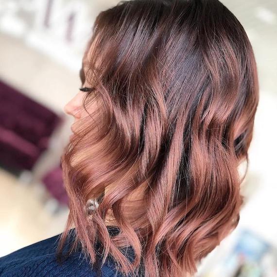 Profile of a person with wavy rose brown hair