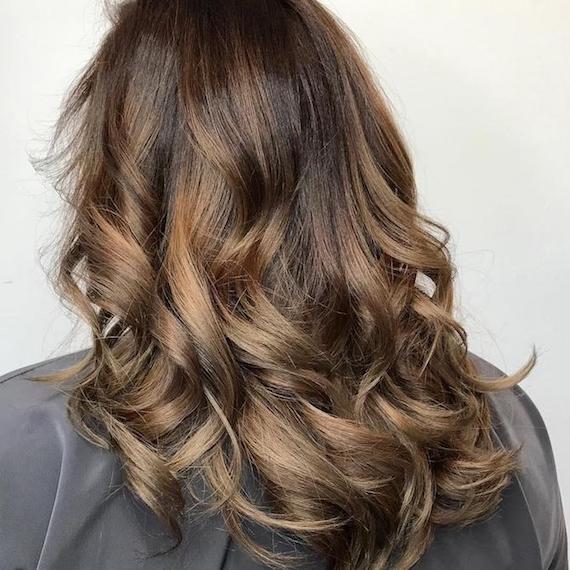 Middle-length brown ombre hair styled into curls