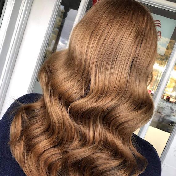 Back of woman’s head with glossy, chestnut brown hair, created using Wella Professionals.