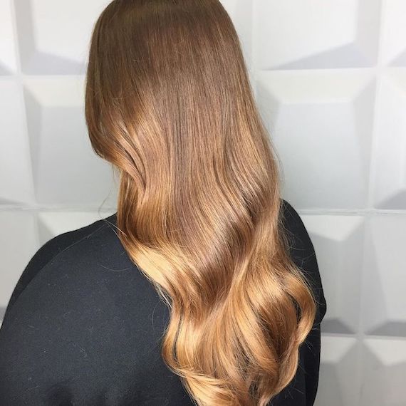 back of head showing long, wavy, caramel brown ombre hair