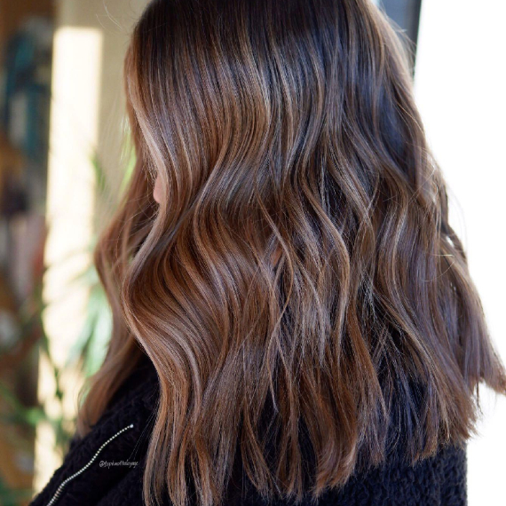 Woman with shoulder-length, chestnut praline hair, created using Wella Professionals