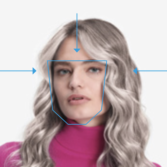 Model with long, tousled, ash blonde hair and icy highlights looks directly into the camera.