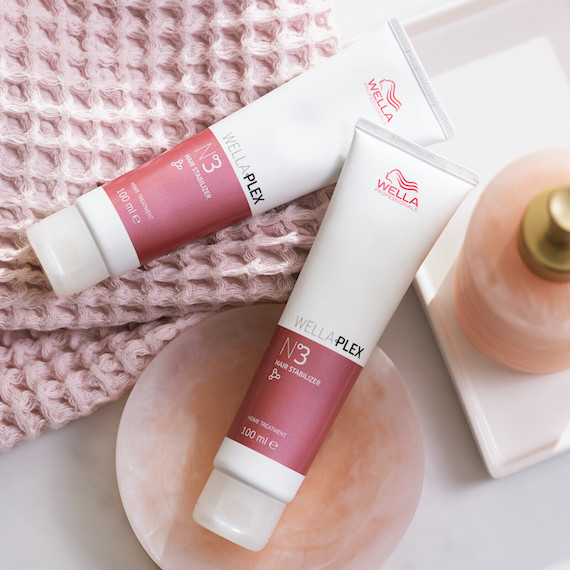 Two bottles of WellaPlex No 3. Hair Stabilizer by Wella Professionals sat on a pick towel and soap dish