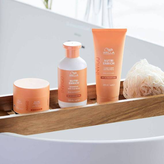 INVIGO Nutri-Enrich Mask, Conditioner and Shampoo on a bath rack.