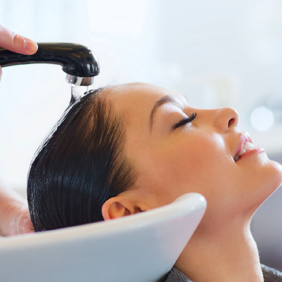 A woman having her hair washed at the salon.
