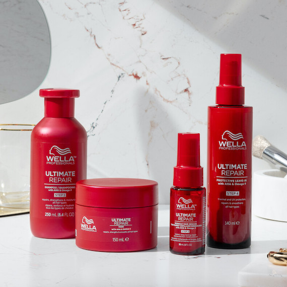 ULTIMATE REPAIR Shampoo, Mask, Miracle Hair Rescue and Protective Leave-In on a marble surface.