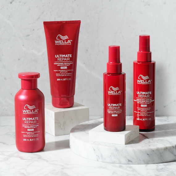 ULTIMATE Repair Shampoo, Conditioner, Miracle Hair Rescue und Protective Leave-In stehen auf einer Marmoroberfläche.