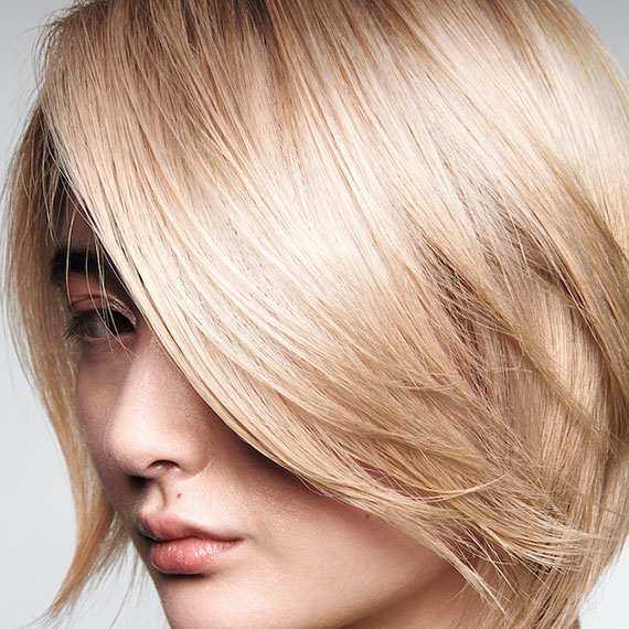 Close-up of model with buttery blonde bob haircut.