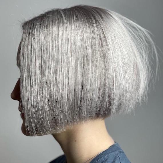 Side profile of woman with grey blunt bob haircut.