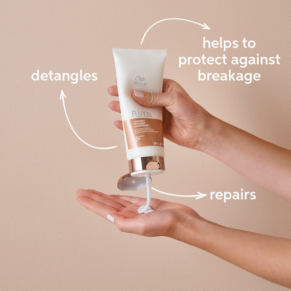 Fusion Intense Repair Conditioner is squeezed into model’s hand.