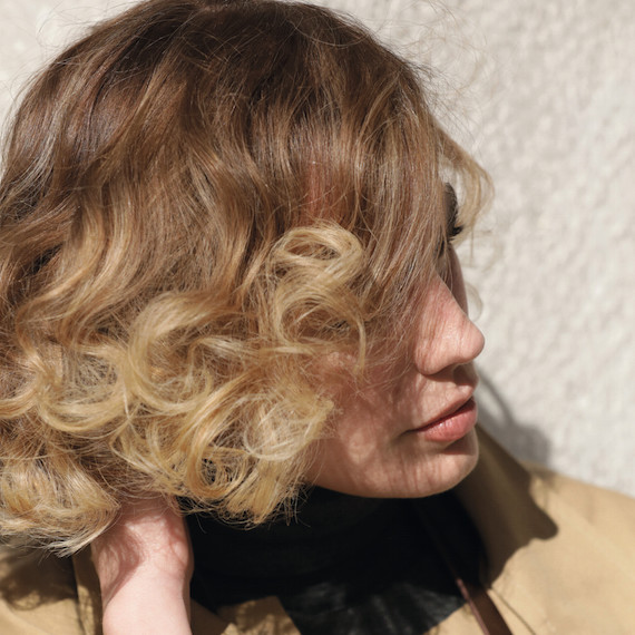 Photo of woman with short, wavy, blonde hair, created using Wella Professionals.