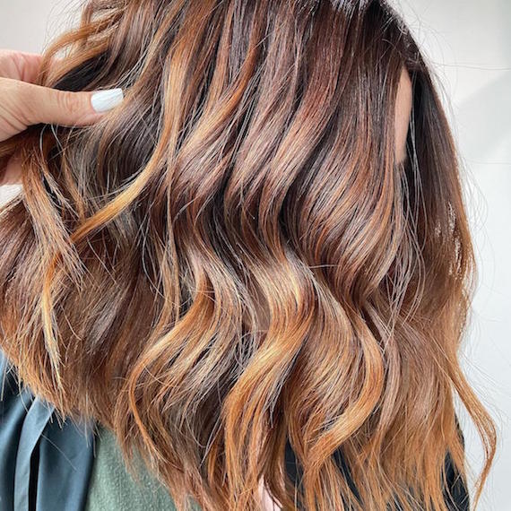 Photo of woman with brown graduated bob haircut, created using Wella Professionals.