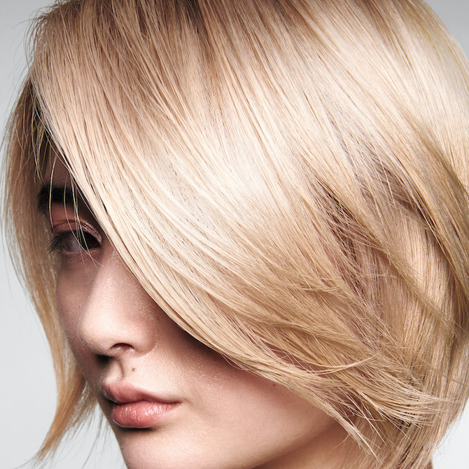 Model with chin-length, butter blonde bob haircut.