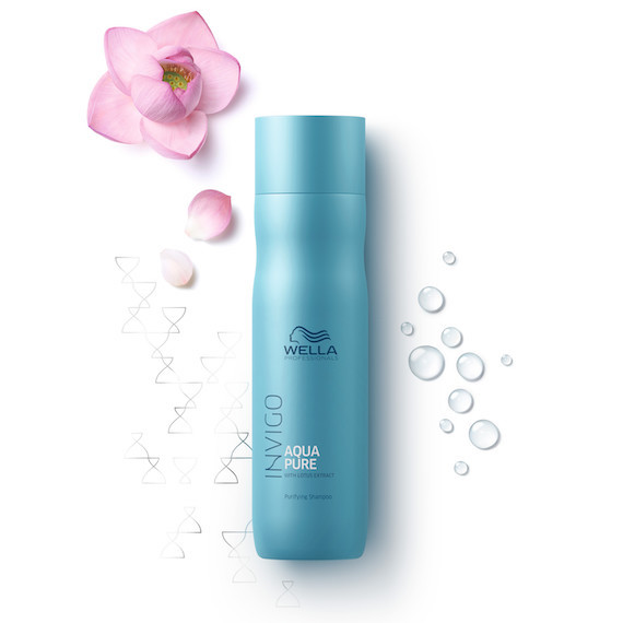 Bottle of INVIGO Aqua Pure Purifying Shampoo next to a lotus flower.