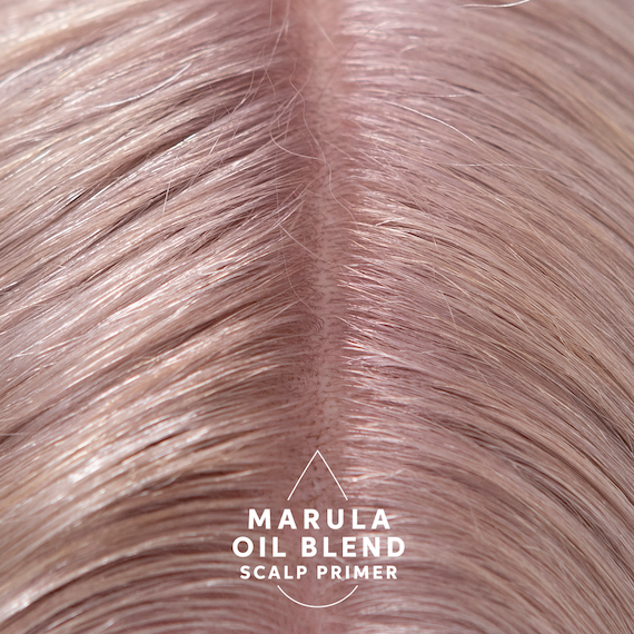 Marula Oil Blend Scalp Primer is applied to model’s scalp.