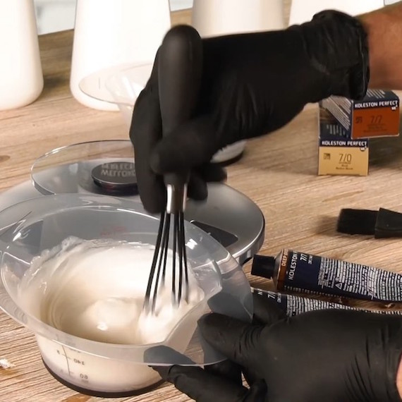 Close-up of hair color being mixed in a bowl.