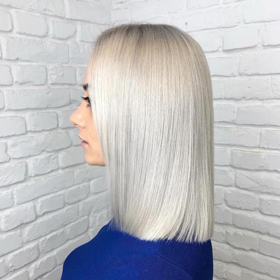Side profile of woman with ice blonde lob, created using Wella Professionals.