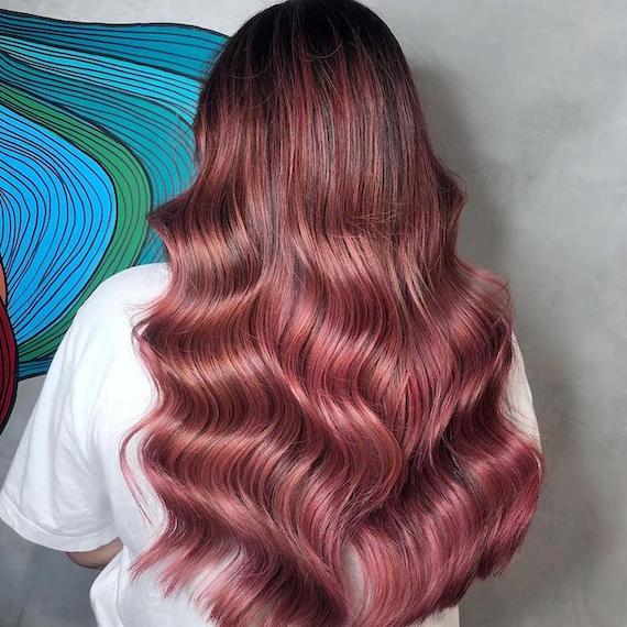 Back of woman’s head with long, rose brown hair, created using Wella Professionals.