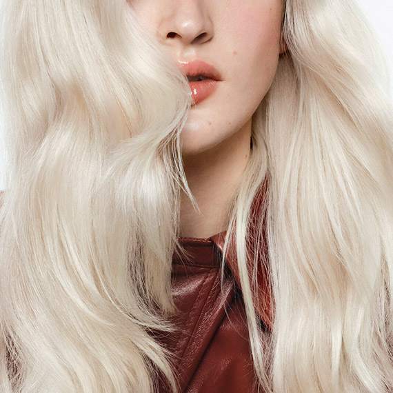Close-up of model’s icy blonde, wavy hair.