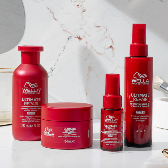 ULTIMATE REPAIR Shampoo, Mask, Miracle Hair Rescue and Protective Leave-In in a marble bathroom.