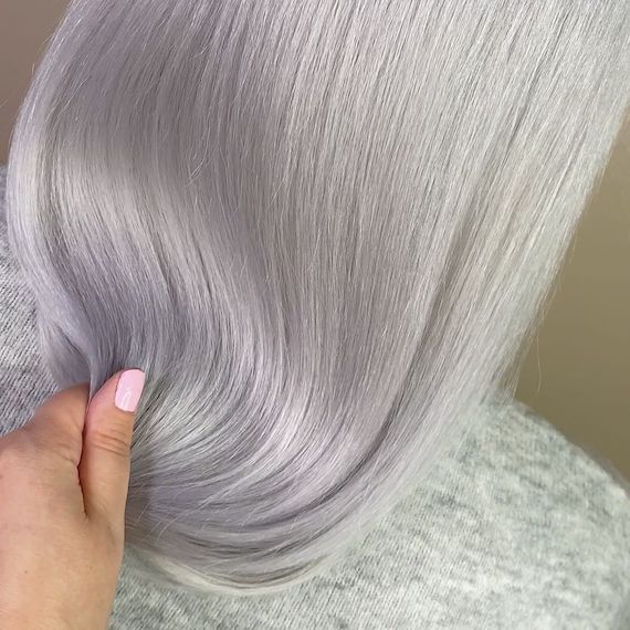 ‘After’ shot showing back of model’s head with long, straight, nordic silver hair.