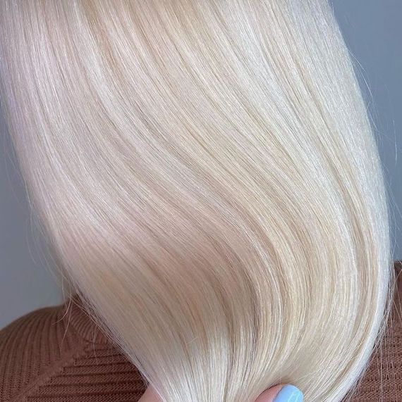‘After’ shot showing back of model’s head with long, straight, nordic blonde hair.