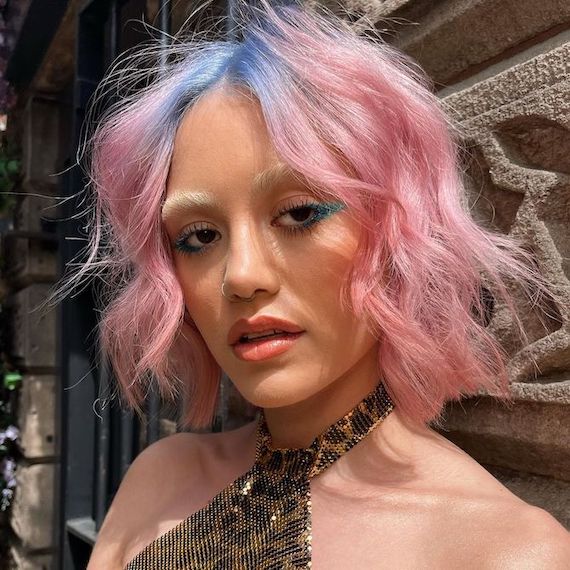 Model with bob haircut featuring blue roots and candy pink lengths.
