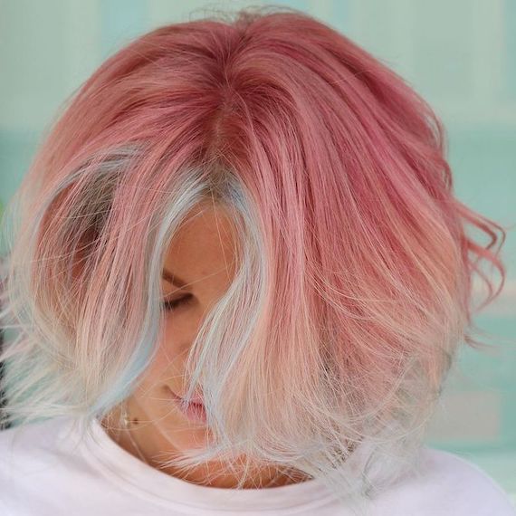 Model with candy pink bob haircut and blue face-framing highlights.