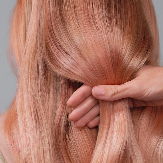 Close-up of model’s peach blonde hair.