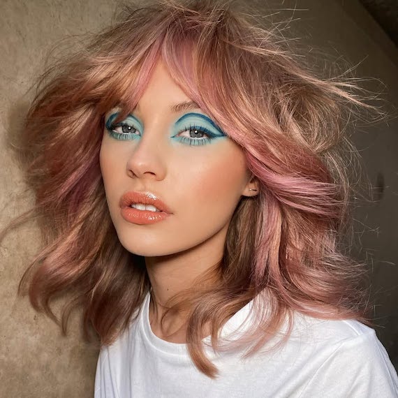 Model with blonde, blow-dried hair, featuring pink highlights courtesy of Color Fresh Mask.