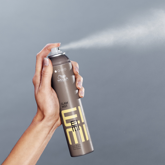 Hand holds EIMI Glam Mist.