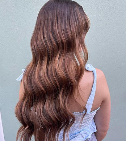 Long, wavy light brown hair that’s been cared for using Wella Professionals Invigo Nutri-Enrich for damaged hair